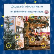 Lösung für Türchen Nr 10: Im Bild sind 6 Brainys versteckt. Darunter ein Bild eines Karussells an einem Weihnachtsmarkt. Comicfiguren eines Gehirns sind mit gelben Linien umkreist.